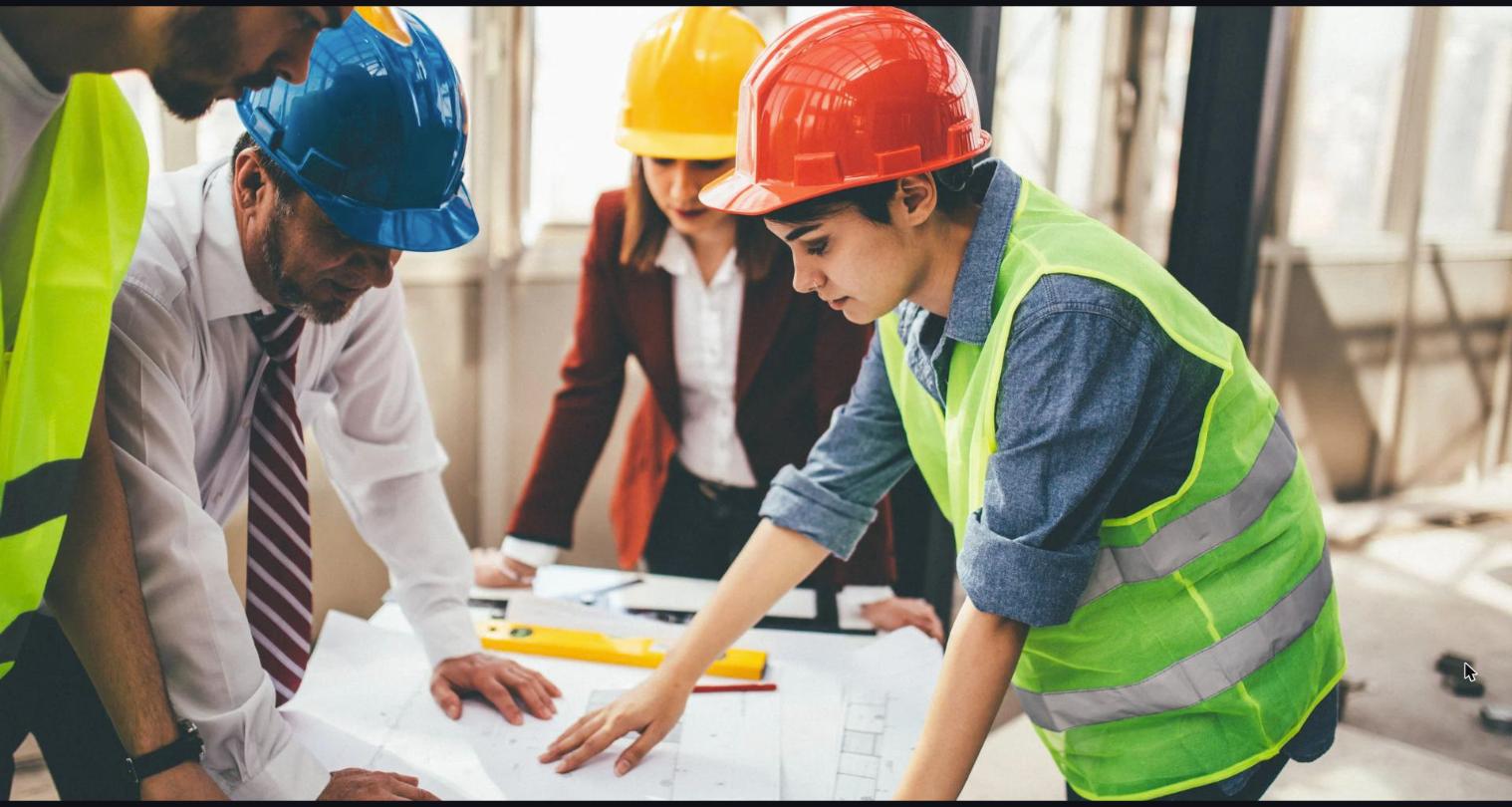 Manpower supply company workers in UAE reviewing project plans on site